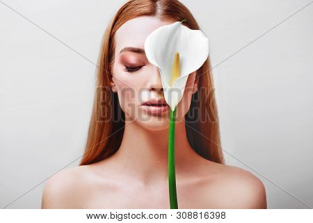 Portrait Of Happy Young Redhead Lady Looking Out Of White Flowers Studio Shot