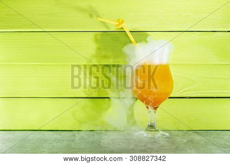 Cocktail With Liquid Nitrogen. Summer Cooling Orange Cocktail In A Glass Beaker With A Straw. From L
