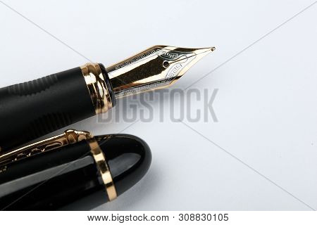 Golden Fountain Pen On A White Paper Closeup