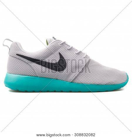 Vienna, Austria - August 25, 2017: Nike Roshe One Qs Grey And Green Sneaker On White Background.