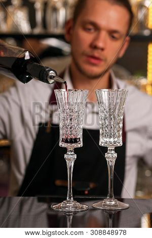 Barmen Is Making Kir Royal Cocktail With Orange Slice And Ice Cubes