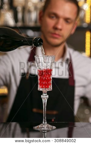 Barmen Is Making Kir Royal Cocktail With Orange Slice And Ice Cubes