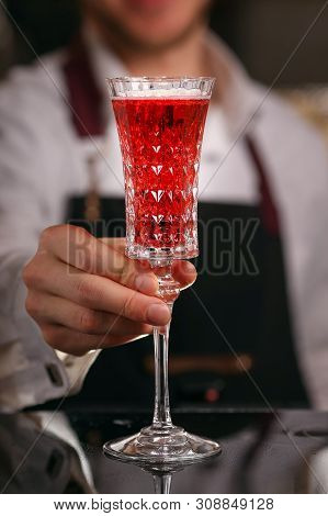Barmen Is Making Kir Royal Cocktail With Orange Slice And Ice Cubes