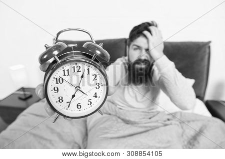 Tips For Becoming An Early Riser. Man Bearded Hipster Sleepy Face In Bed With Alarm Clock. Problem W