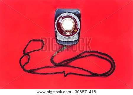 Old Vintage Soviet Exposure Meter With Leather Case On Red Background