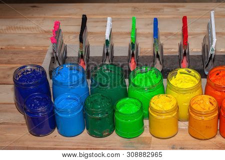 Colorful Plastisol Ink In Transparent Bottles In Screen Printing Tee Shirt Factory Store.