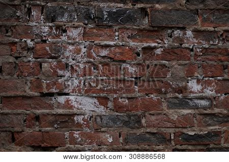 The Wall Is Made Of Bricks Of Red, Gray, Black Colors, Having A Pronounced Texture.