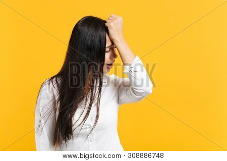 Portrait Of Crying Frustrated Nervous Young Woman In White Casual Shirt Putting Hand On Head Isolate