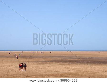 Southport, Merseyside, United Kingdom - 28 June 2019: A Group Of Young Women Walking Onto The Long B