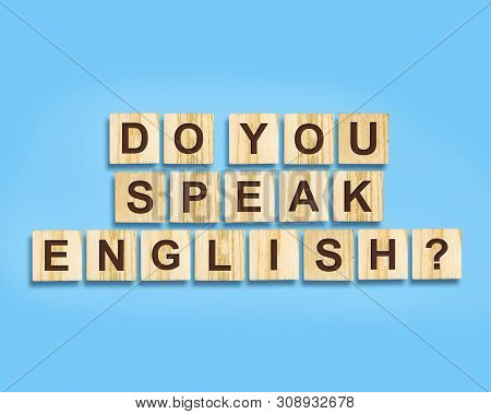 Do You Speak English The Inscription On The Wood Blocks, Isolated, Blue Background. Concept For Scho