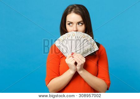 Beautiful Brunette Young Woman Wearing Red Orange Dress Holding Fan Of Cash Money In Dollar Banknote