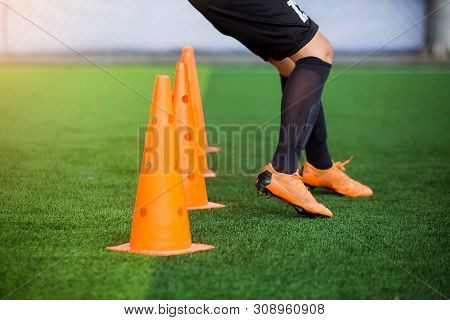Kid Soccer Players Jogging And Jump Between Cone Markers On Green Artificial Turf For Soccer Trainin