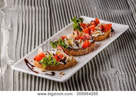 Bruschetta With Tomatoes, Lettuce, Camambert, Balsamic Vinegar