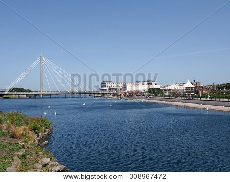 Southport, Merseyside, United Kingdom - 28 June 2019: The Suspension Bridge And Pier Crossing The La
