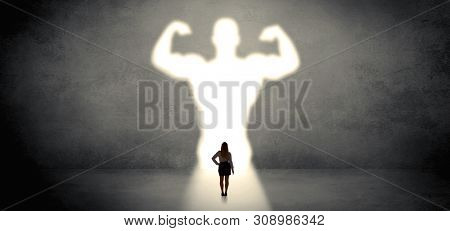 Woman standing and dreaming about a strong superhero