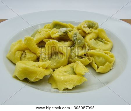 Tortelloni With Ricotta Cheese And Spinach On White Dish