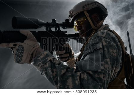View Of American Ranker With Armour Confidently Standing With Weapon And Looking At Side. African So