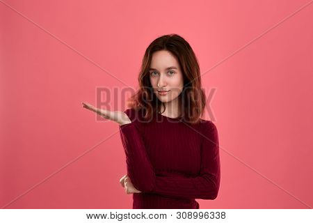 Excited Young Lady Standing Isolated Over Dark Pink Background Looking At You With A Palm Of A Hand 