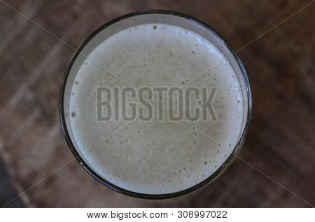 Close Up Of Glass Filled With Radler, Mixture Of Beer And Sparkling Lemonade, On Wooden Background