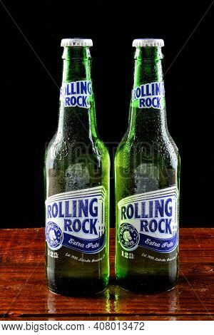 IRVINE, CALIFORNIA - 18 JUNE 2015: Two bottles of Rolling Rock Extra Pale beer on a wet bar countertop.