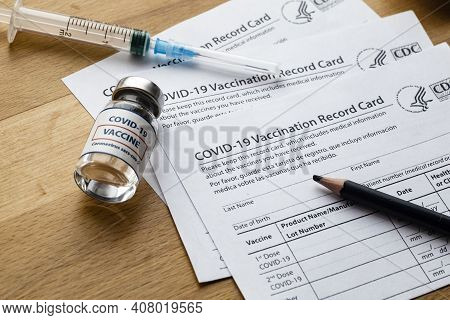 Vaccination Record Card. Vaccination Form During The Coronavirus Epidemic On The Medical Table