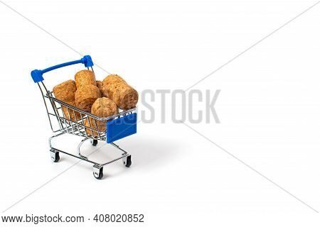 A Handful Of Champagne Corks In A Blue Shopping Cart. Isolate On A White Background. Copspace