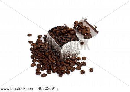 Roasted Coffee Beans In A Small Metal Chest Around It. Isolate On A White Background. Copspace