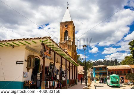 Raquira, Colombia - February 2021. Tower Of The San Antonio Church And The Streets Around Raquira Ci
