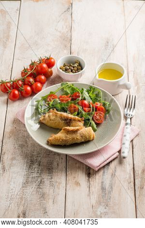 rolled sword fish with capers arugula and tomatoes salad