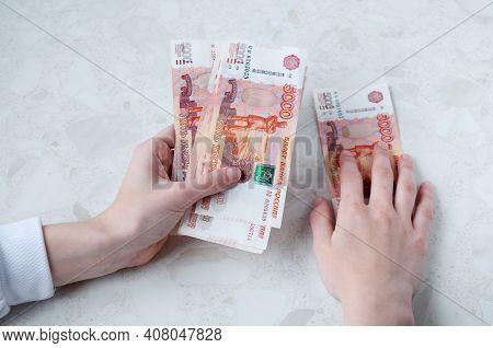 A Lot Of Russian Five-thousand-dollar Bills In Women's Hands, The Concept Of Big Money