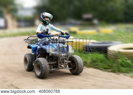 A Child Rides An Atv On The Track