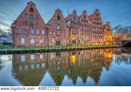 The Historic Salzspeicher With The Trave River At Dawn, Seen In Luebeck, Germany