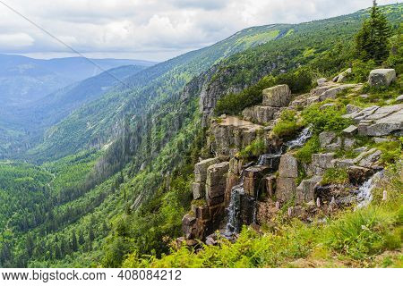 High Waterfall With A Beautiful Landscape Of The Mountains In The Czech Republic