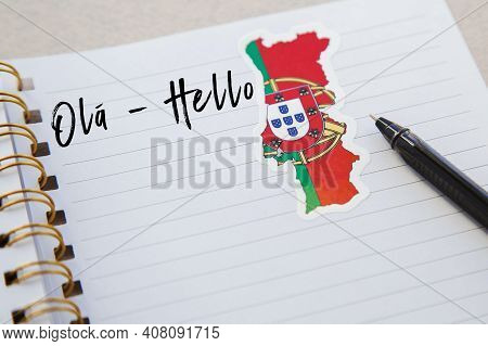 Notepad With The Words Hello In Portuguese Language, Portuguese Flag And Country Map, Pen, Foreign L