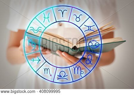 Young Woman Reading Book And Illustration Of Zodiac Wheel With Astrological Signs On Light Backgroun