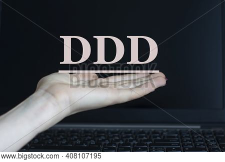 Ddd (domain Driven Design) - Acronym On A Woman's Hand Against The Background Of A Laptop. Internet 