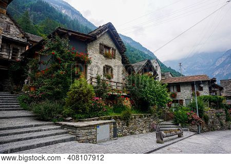 Traditional Rustic Stone House With Lots Of Flowers Spotted In The Beautiful Village Sonogno, Ticino