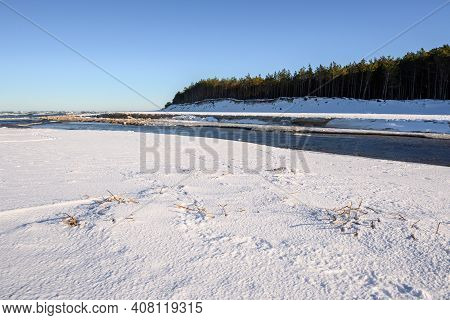 Snow Covered Beach On The Baltic Sea. Piasnica River, Debki, Poland