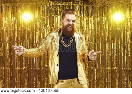 Uninhibited Bearded Man In Shiny Golden Suit Dancing And Having Fun At Disco Party