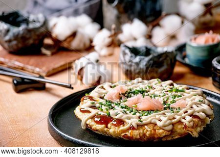 Homemade Japanese Fast Food Okonomiyaki Cabbage Pancake With Onion, Pickled Ginger, Mayo Sauce On Bl
