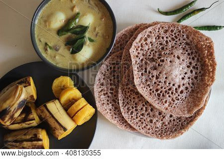 Hoppers Made Of Finger Millet Served With Egg Stew Prepared In Kerala Style And Steamed Plantain.