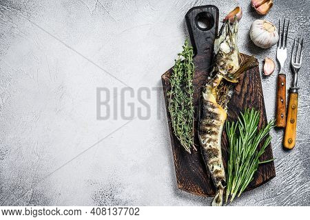 Cooked Mackerel Icefish On A Wooden Cutting Board. Black Background. Top View. Copy Space
