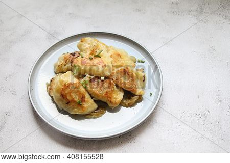 Fried Dumplings, Crispy Dumplings With Fried Onion, Round Plate Full Of Hot Dumplings Sprinkled With