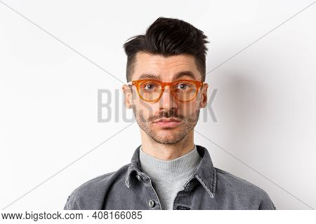 Attractive Brunette Man With Moustache, Wearing Stylish Glasses And Look Serious At Camera, No Emoti