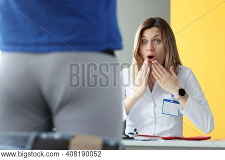 Woman Doctor Examining Patient In Shorts And Is Surprising. Diagnosis Of Sexually Transmitted Infect