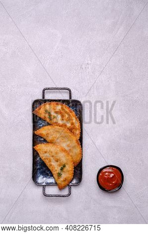 Fried Burekas With Filling On A Light Stone Background. Top View. Selective Focus.