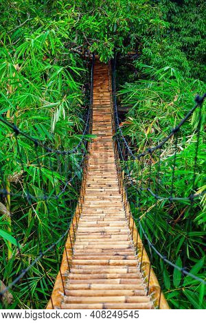 Traditional Construction Suspension Pedestrian Bridge Made From Natural Bamboo. Cable Bridge Crossin