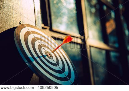 Dart Arrow Hit On Bulleyes Of Dartboard To Represent That The Business Reached The Target  With Dark