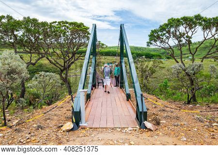 Capitólio - Mg, Brazil - December 08, 2020: Tourists Crossing The Suspension Bridge Of The Belvedere