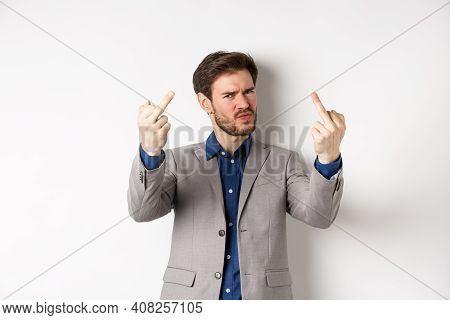 Rude Businessman In Suit Showing Middle Finger, Fuck You Gesture, Look Annoyed And Pissed-off, Stand